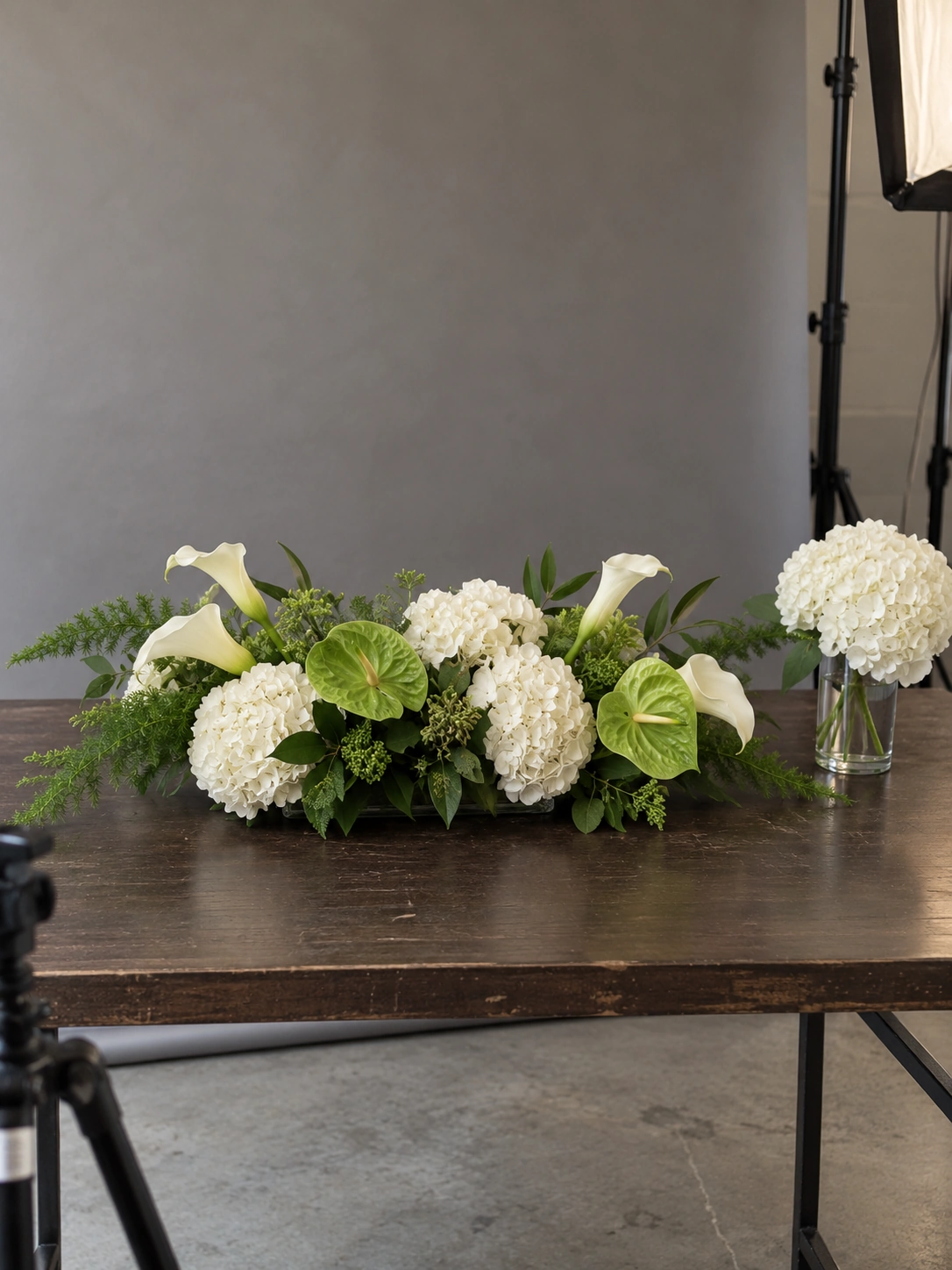AI design study of a practical white and green floral centerpiece in a working photo studio